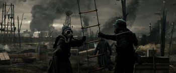 Movie still from “Sucker Punch” (2011), directed by Zack Snyder – A group of men in gas masks are fighting over a rope ladder; Medium shot, Low angle
