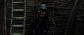 Movie still from “Sucker Punch” (2011), directed by Zack Snyder – A man dressed as a zombie holding a rifle; Close Up shot, Low angle