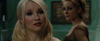 Movie still from “Sucker Punch” (2011), directed by Zack Snyder – A woman with blonde hair and blue eye shadow; Close Up shot, Over the shoulder angle
