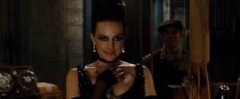 Movie still from “Sucker Punch” (2011), directed by Zack Snyder – A woman in a black and white dress and a black glove; Close Up shot, Over the shoulder angle