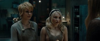 Movie still from “Sucker Punch” (2011), directed by Zack Snyder – Two young women standing next to each other in a room; Close Up shot, Over the shoulder angle