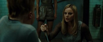 Movie still from “Sucker Punch” (2011), directed by Zack Snyder – A woman holding a knife in front of another woman; Close Up shot, Over the shoulder angle