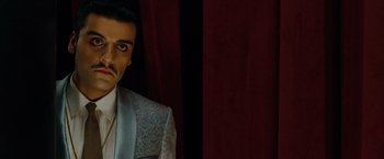 Movie still from “Sucker Punch” (2011), directed by Zack Snyder – A person wearing a suit and tie; Close Up shot, Over the shoulder angle