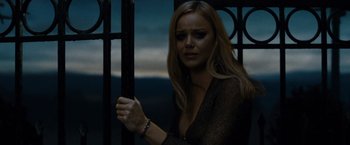 Movie still from “Sucker Punch” (2011), directed by Zack Snyder – A beautiful woman standing in front of a gate; Close Up shot, Low angle