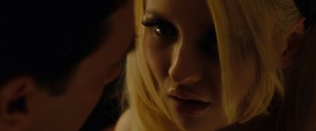 Movie still from “Sucker Punch” (2011), directed by Zack Snyder – A woman's face with long eyelashes; Extreme Close Up shot, Over the shoulder angle
