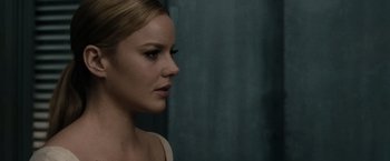 Movie still from “Sucker Punch” (2011), directed by Zack Snyder – A beautiful woman with blonde hair looking to the side; Close Up shot, Over the shoulder angle