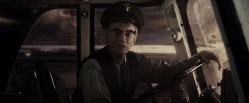 Movie still from “Sucker Punch” (2011), directed by Zack Snyder – An older man wearing a hat driving a car; Close Up shot, Over the shoulder angle