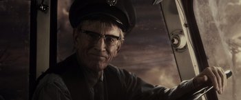 Movie still from “Sucker Punch” (2011), directed by Zack Snyder – An old man wearing glasses and a hat; Close Up shot, Low angle