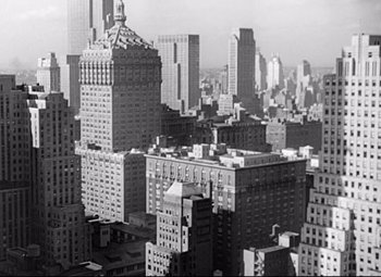 Movie still from “Sudden Fear” (1952), directed by David Miller – A black - and - white photo of a city skyline; Extreme Wide shot, High angle