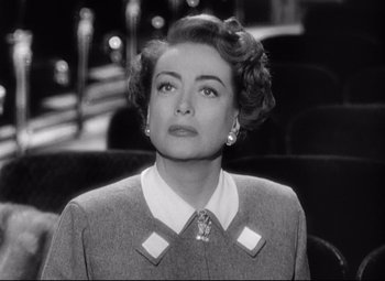 Movie still from “Sudden Fear” (1952), directed by David Miller – An old black and white photo of a woman; Close Up shot, Low angle