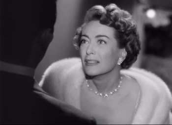 Movie still from “Sudden Fear” (1952), directed by David Miller – An old photo of a woman in a fur coat; Close Up shot, Over the shoulder angle
