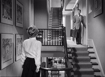 Movie still from “Sudden Fear” (1952), directed by David Miller – A man and a woman walking down a staircase; Wide shot, High angle