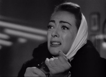 Movie still from “Sudden Fear” (1952), directed by David Miller – An old black and white photo of a woman crying; Close Up shot, Low angle