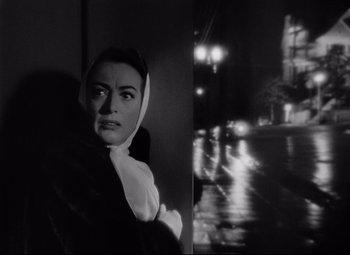 Movie still from “Sudden Fear” (1952), directed by David Miller – A black and white photo of a woman wearing a white scarf; Close Up shot, Low angle
