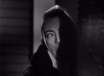 Movie still from “Sudden Fear” (1952), directed by David Miller – A black - and - white photo of a woman's face; Close Up shot, Low angle