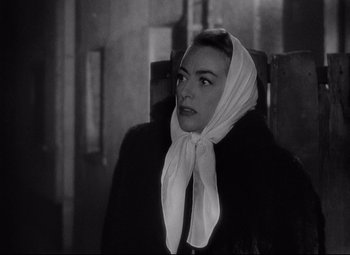 Movie still from “Sudden Fear” (1952), directed by David Miller – A black and white photo of a woman wearing a white scarf; Close Up shot, Low angle
