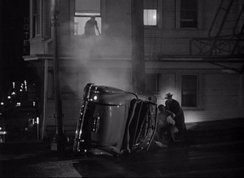 Movie still from “Sudden Fear” (1952), directed by David Miller – A truck that is on the side of the road; Wide shot, High angle