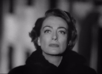 Movie still from “Sudden Fear” (1952), directed by David Miller – An old photo of an older woman looking at the camera; Close Up shot, Low angle