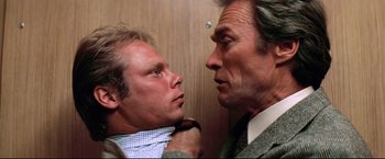 Movie still from “Sudden Impact” (1983), directed by Clint Eastwood – A man and a woman looking at one another in the mirror; Close Up shot, Over the shoulder angle