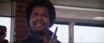 Movie still from “Sudden Impact” (1983), directed by Clint Eastwood – A person holding a gun; Close Up shot, Low angle