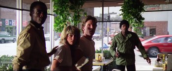 Movie still from “Sudden Impact” (1983), directed by Clint Eastwood – A man and a woman are standing in front of a window; Medium shot, Over the shoulder angle