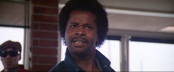 Movie still from “Sudden Impact” (1983), directed by Clint Eastwood – A person wearing a jean shirt; Close Up shot, Low angle