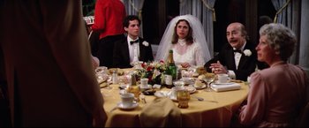 Movie still from “Sudden Impact” (1983), directed by Clint Eastwood – A bride and groom sitting at a dinner table; Medium shot, Over the shoulder angle
