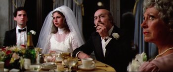 Movie still from “Sudden Impact” (1983), directed by Clint Eastwood – A man and a woman sitting at a dinner table; Medium shot, Over the shoulder angle