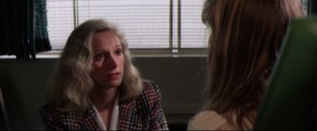 Movie still from “Sudden Impact” (1983), directed by Clint Eastwood – A woman sitting in front of another woman in front of a window; Close Up shot, Over the shoulder angle