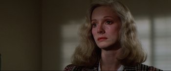 Movie still from “Sudden Impact” (1983), directed by Clint Eastwood – A person with long blonde hair; Close Up shot, Over the shoulder angle