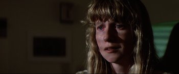 Movie still from “Sudden Impact” (1983), directed by Clint Eastwood – A person with a crying face; Close Up shot, Over the shoulder angle