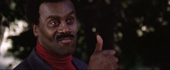 Movie still from “Sudden Impact” (1983), directed by Clint Eastwood – A person giving a thumbs up; Close Up shot, Low angle