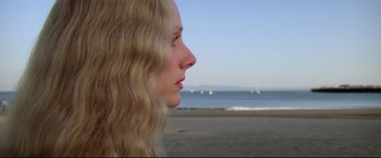 Movie still from “Sudden Impact” (1983), directed by Clint Eastwood – A person on a beach near the ocean; Close Up shot, Low angle