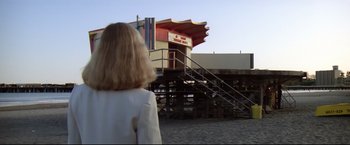 Movie still from “Sudden Impact” (1983), directed by Clint Eastwood – A woman standing in front of a building with stairs; Wide shot, Low angle