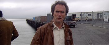 Movie still from “Sudden Impact” (1983), directed by Clint Eastwood – A person wearing a brown jacket; Close Up shot, Low angle