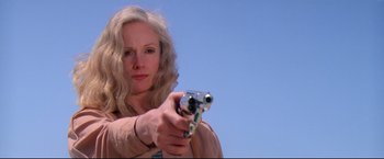 Movie still from “Sudden Impact” (1983), directed by Clint Eastwood – A woman holding a gun in her hand; Close Up shot, Low angle