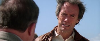 Movie still from “Sudden Impact” (1983), directed by Clint Eastwood – A person talking to another person; Close Up shot, Over the shoulder angle