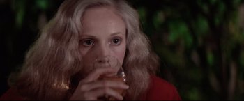 Movie still from “Sudden Impact” (1983), directed by Clint Eastwood – A person holding a glass of beer; Close Up shot, Over the shoulder angle