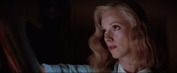 Movie still from “Sudden Impact” (1983), directed by Clint Eastwood – A person with long blonde hair; Close Up shot, Low angle