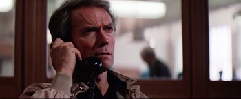 Movie still from “Sudden Impact” (1983), directed by Clint Eastwood – A person talking on a phone; Close Up shot, Low angle