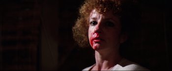 Movie still from “Sudden Impact” (1983), directed by Clint Eastwood – A person with red lipstick on her face; Close Up shot, Low angle