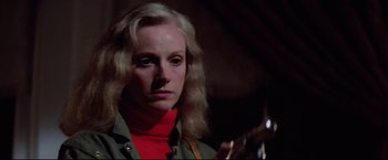 Movie still from “Sudden Impact” (1983), directed by Clint Eastwood – A woman with blonde hair holding a guitar; Close Up shot, Over the shoulder angle