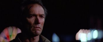 Movie still from “Sudden Impact” (1983), directed by Clint Eastwood – A person with a scar on his face; Close Up shot, Low angle