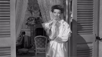 Movie still from “Suddenly, Last Summer” (1959), directed by Joseph L. Mankiewicz – An old photo of a woman standing in front of a chair; Medium shot, Low angle