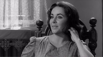 Movie still from “Suddenly, Last Summer” (1959), directed by Joseph L. Mankiewicz – An old photo of an older woman with her hand on her head; Close Up shot, Over the shoulder angle