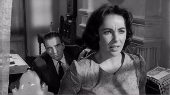 Movie still from “Suddenly, Last Summer” (1959), directed by Joseph L. Mankiewicz – A man and a woman sitting in a chair; Close Up shot, Over the shoulder angle