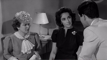 Movie still from “Suddenly, Last Summer” (1959), directed by Joseph L. Mankiewicz – Two women and a young man in a room; Medium shot, Over the shoulder angle