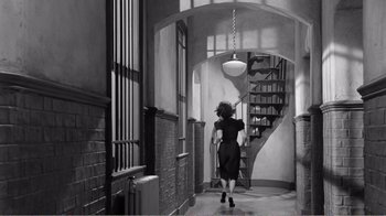 Movie still from “Suddenly, Last Summer” (1959), directed by Joseph L. Mankiewicz – A black and white photo of a woman walking down a hallway; Wide shot, High angle