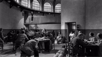 Movie still from “Suddenly, Last Summer” (1959), directed by Joseph L. Mankiewicz – A group of people sitting around a table; Wide shot, High angle