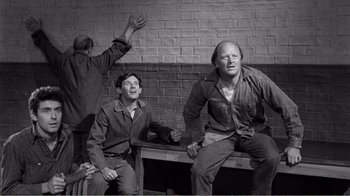 Movie still from “Suddenly, Last Summer” (1959), directed by Joseph L. Mankiewicz – A group of men sitting next to each other on top of a bench; Medium shot, High angle